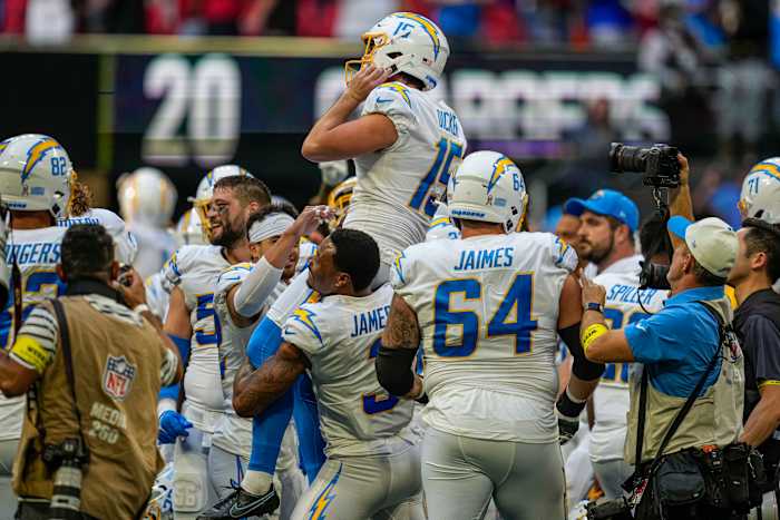Chargers players lift kicker Cameron Dicker on their shoulders after a game-winning kick to beat the Falcons